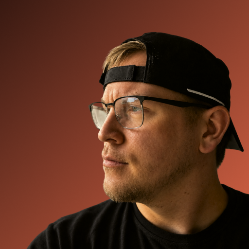 Sam Elsner wearing glasses and a black cap.